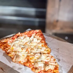 a slice of pizza on a plate