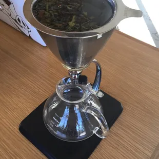Looks like a science experiment, right?It&apos;s white jasmine peach tea. Steep 4 minutes, turn knob so tea drips into small pitcher.