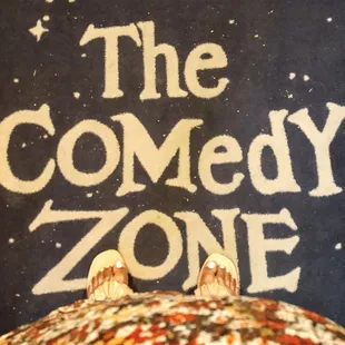 a person standing in front of a sign