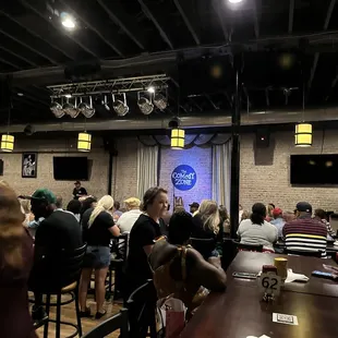 a crowd of people sitting around a table