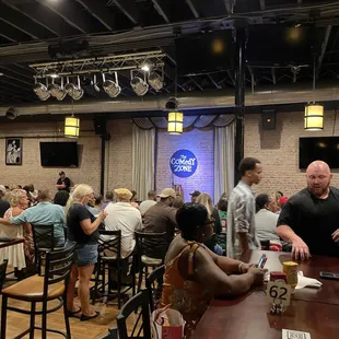 a crowd of people sitting at tables