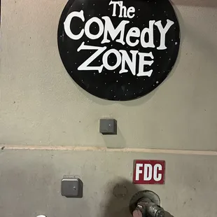 a man laying on the ground in front of a sign