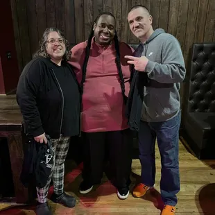 two men and a woman posing for a picture