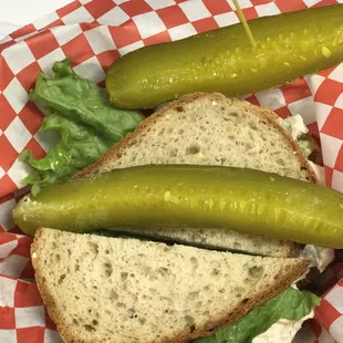 a sandwich with pickles and lettuce