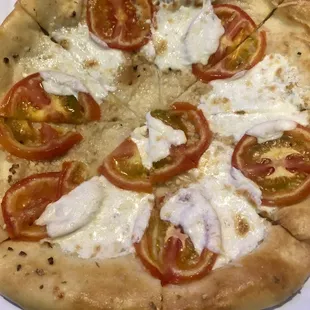 a pizza with tomatoes and cheese