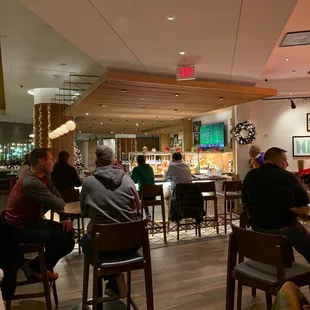 a group of people sitting at a bar