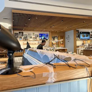 a man behind a counter in a restaurant