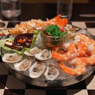 Large seafood platter with oysters, jumbo shrimp, lobster salad, half lobster tail, smoked clams, and chef's choice of sous vide octopus.