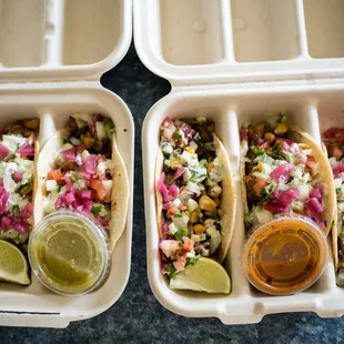 two tacos in a styrofoam container