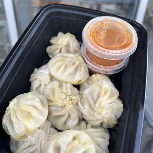 a container of steamed dumplings