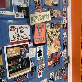 a blue door covered in stickers