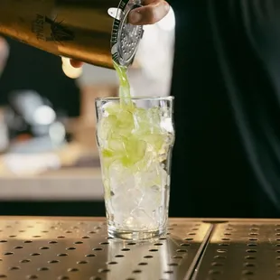  bartender pouring a drink