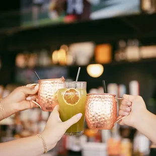 wo people toasting at a bar