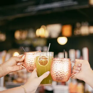 two people toasting at a bar