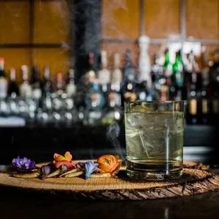 a glass of alcohol and a plate of cookies