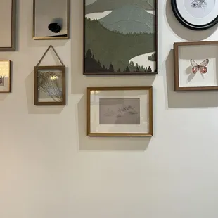 a wall of framed art