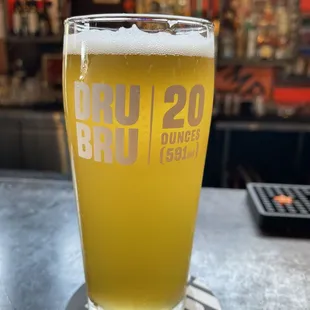 a glass of beer on a coaster