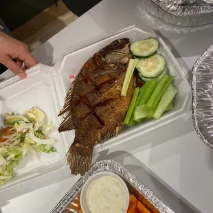 a fish and vegetables on a table