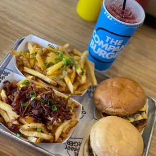 Company burgers with cheese fries, chives and bacon