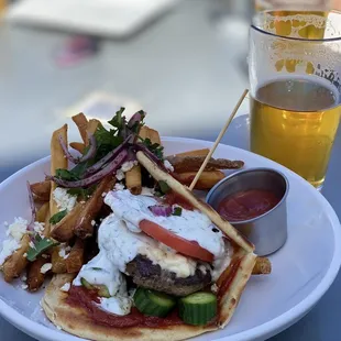 a plate of food and a glass of beer