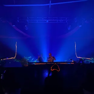 a dj in front of a stage