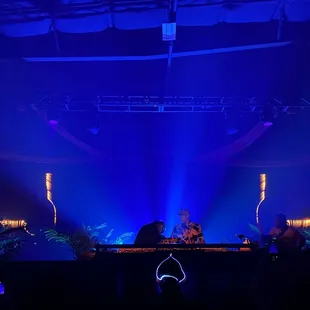 a dj in front of a stage