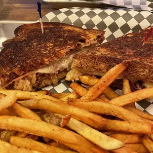 a grilled sandwich and fries