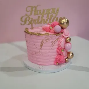 a pink birthday cake