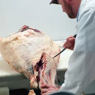 a man cutting a carnivor