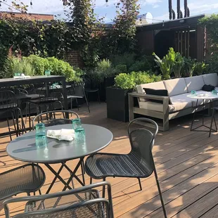 a patio with tables and chairs