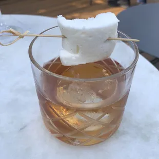 a cocktail with a marshmallow on top