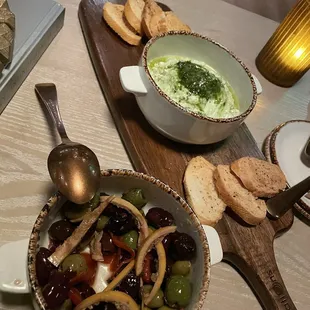 Marinated olives and goat cheese with pesto appetizers.