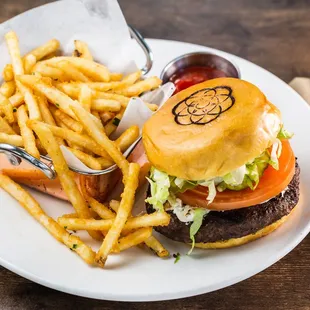 Consulate Burger - 8oz burger grilled to perfection, caramelized onions, goat cheese, shredded lettuce, tomato on a brioche