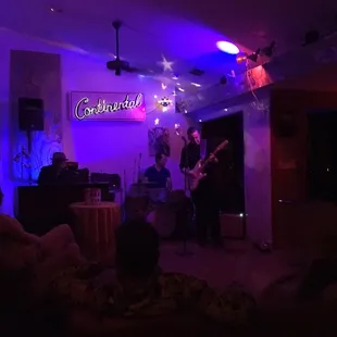 a band playing in a dimly lit room