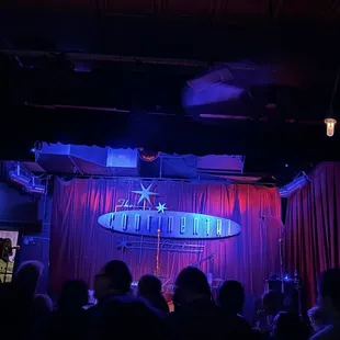 a man on stage with a surfboard