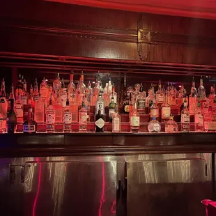 a row of liquor bottles on the bar