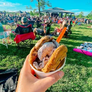a person holding a bowl of ice cream