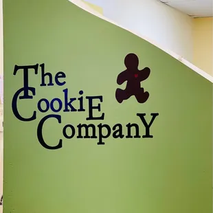 a logo on a green wall