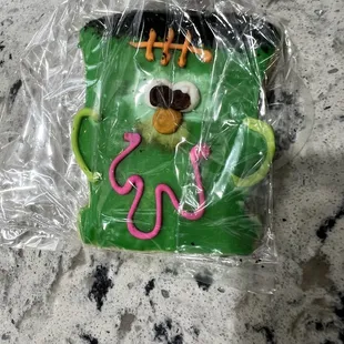 a green monster cookie wrapped in plastic