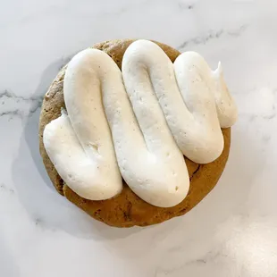a close up of a cookie with white frosting