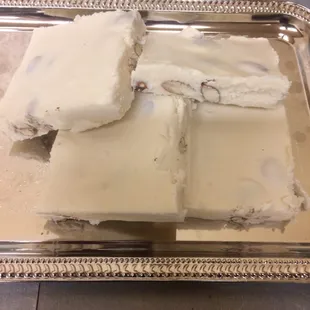 four pieces of white chocolate on a silver tray