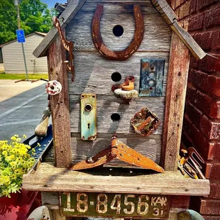 a birdhouse made of wood and metal