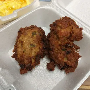 a tray of fried food with eggs and hash browns