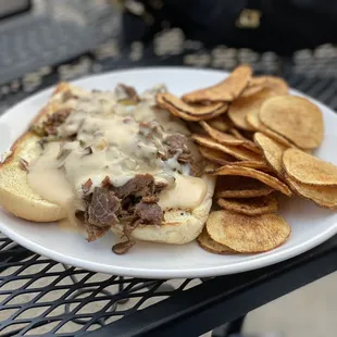 Philly cheesesteak covered in beer cheese and homemade chips (great seasoning).