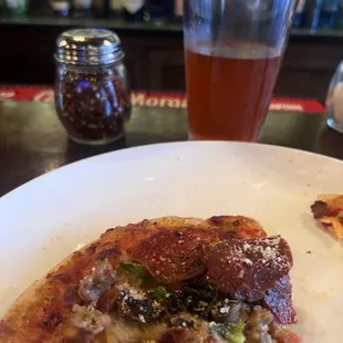 a slice of pizza and a glass of beer