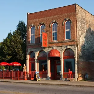 a brick building with red awnings