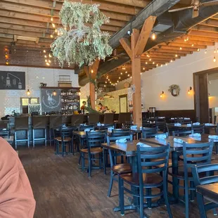 a restaurant with wooden tables and chairs