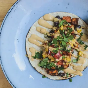 Sweet Potato Vegan Taco Roasted Sweet Potato, Black Beans, Roasted Corn Salsa, Vegan Chipotle Aioli, &amp; Cilantro