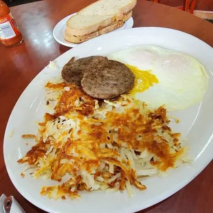 Eggs, meat, hash browns, toast breakfast