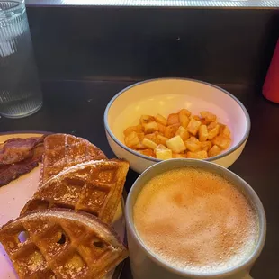 a plate of waffles and a cup of coffee